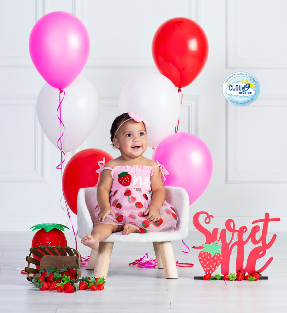 baby girl first birthday portrait in a Sweet One strawberry themed setting at Cloud 9 Studios