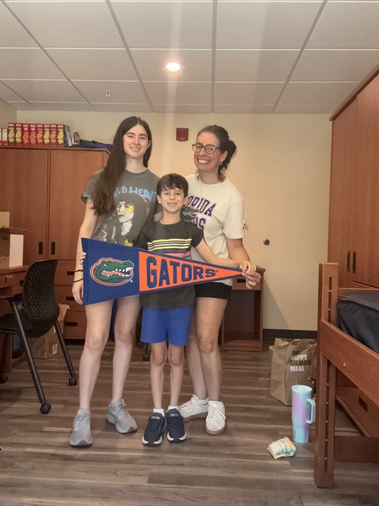 cell phone selfie of jeanine and family moving eryn into her college dorm.
