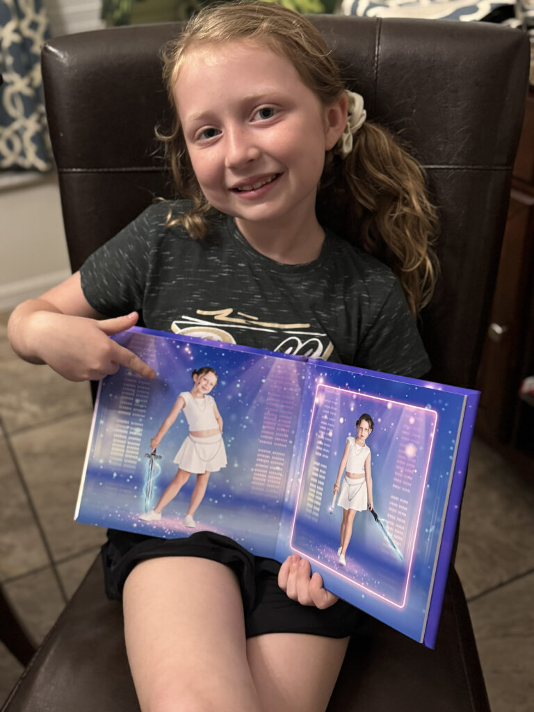 child holding her KPop Demon Hunter inspired birthday storybook album in Wesley Chapel, Florida