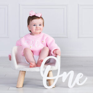 Baby sitting in classic white scene at Cloud 9 Studios first birthday session in Wesley Chapel.