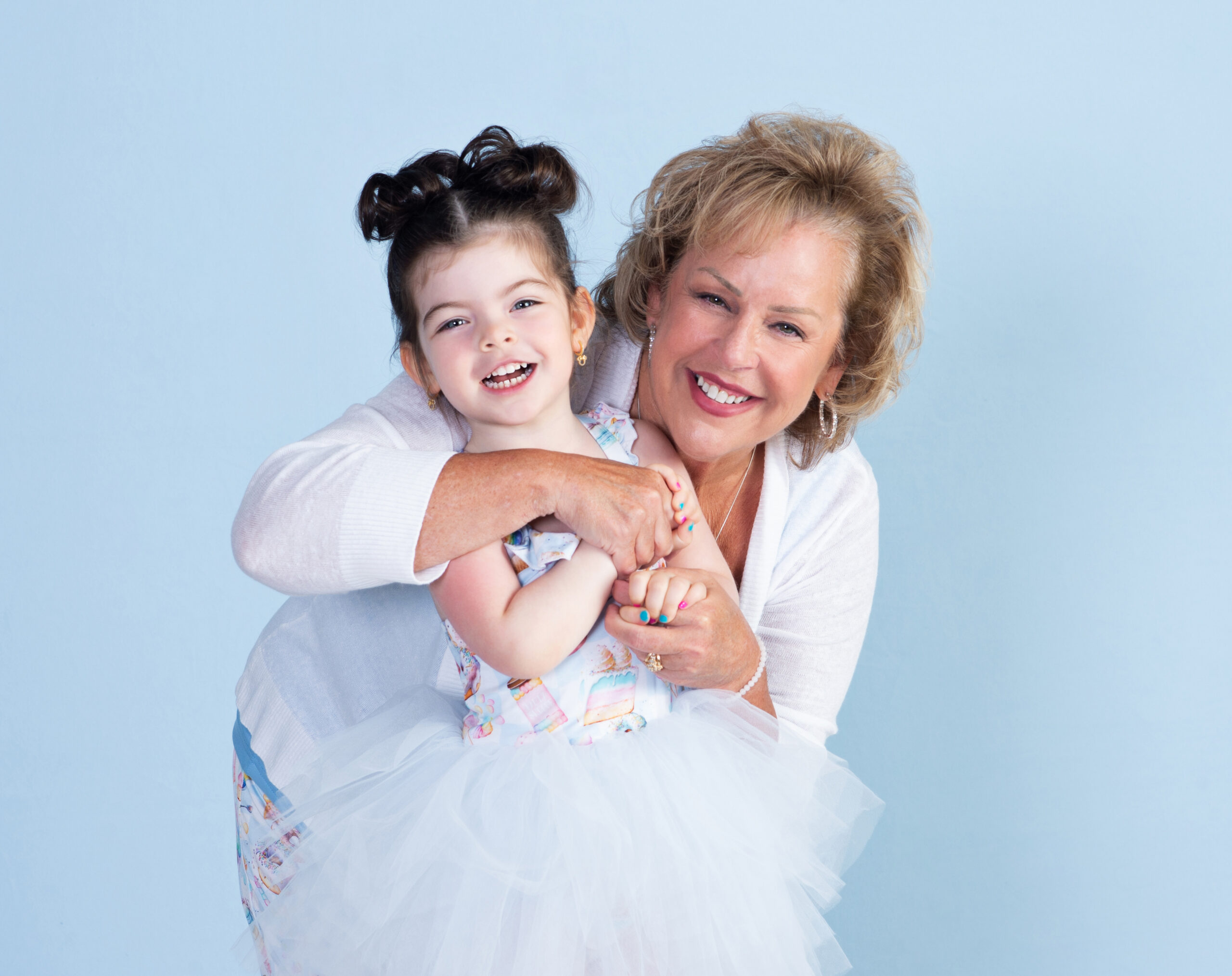 Grandmother and Granddaughter in a hug laughing and enjoying an embrace together at Cloud 9 Studios, in Wesley Chapel, Florida
