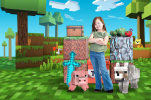 a child standing confidently in a scene created for Minecraft at Cloud 9 Studios in Wesley Chapel, Florida