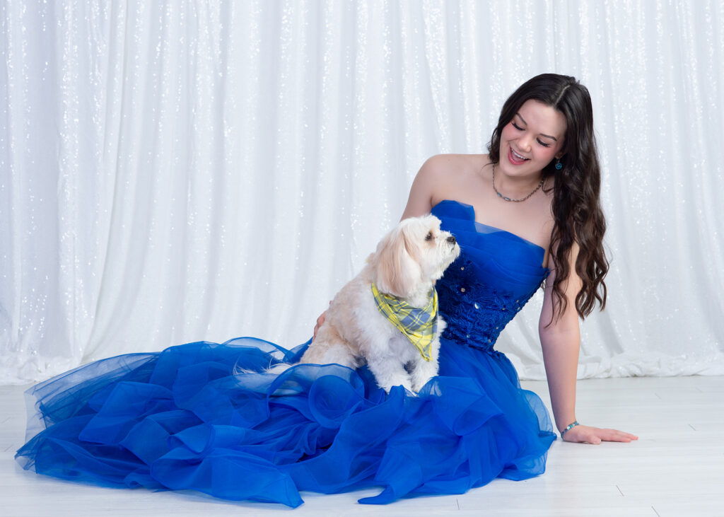 teenage girl in the studio with her dog on her lap laughing and interacting together in Wesley Chapel, Fl