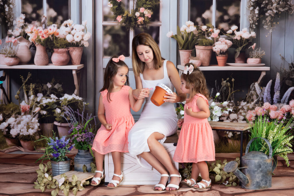 A mother painting pottery with her daughters as they enjoy time together at Cloud 9 Studios in Wesley Chapel, Florida