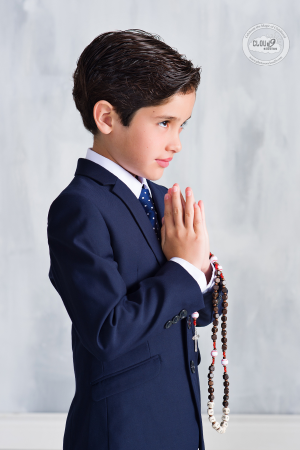 A young boy praying for his First Holy Communion in Wesley Chapel, Florida