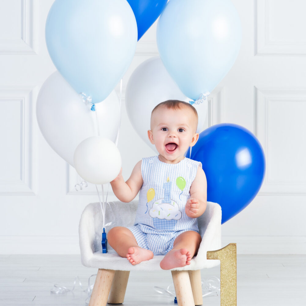 One year old child laughing during first birthday portrait experience Wesley Chapel Florida