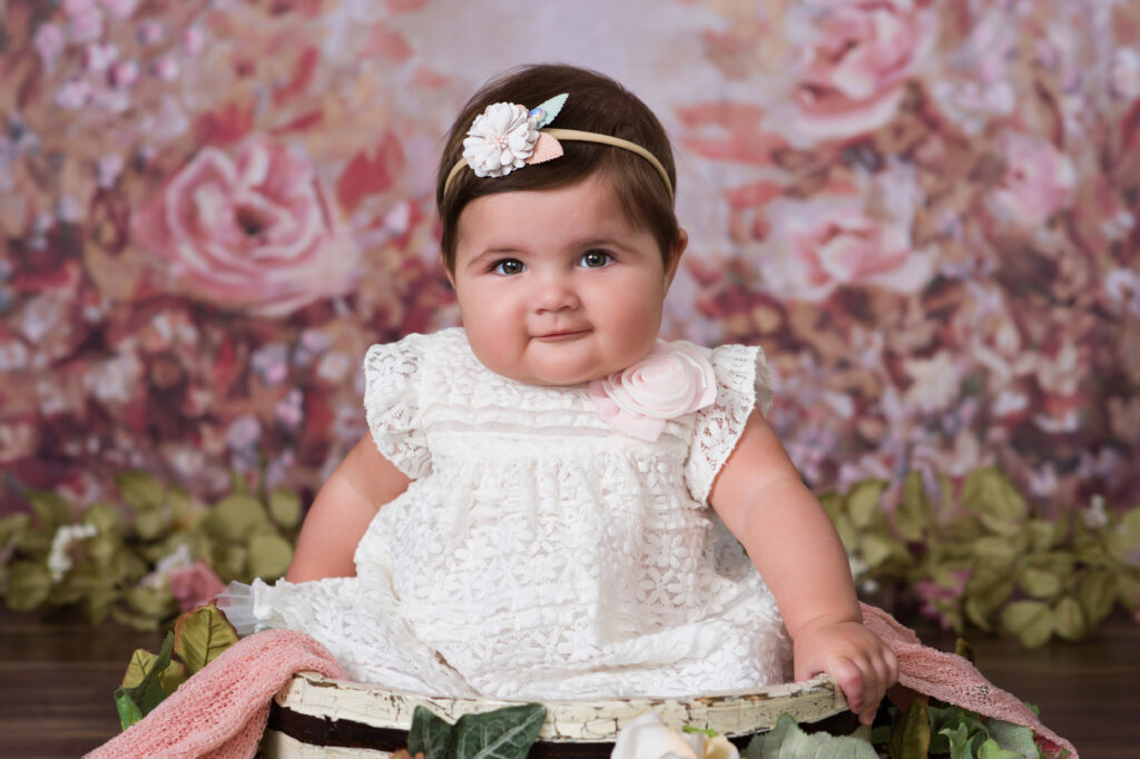 Close up of six month old baby smiling during portrait experience at Cloud 9 Studios Florida