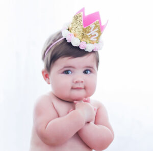 6 month old baby with a half birthday crown on with chubby cheeks and a smile at Cloud 9 Studios in Wesley Chapel, Florida