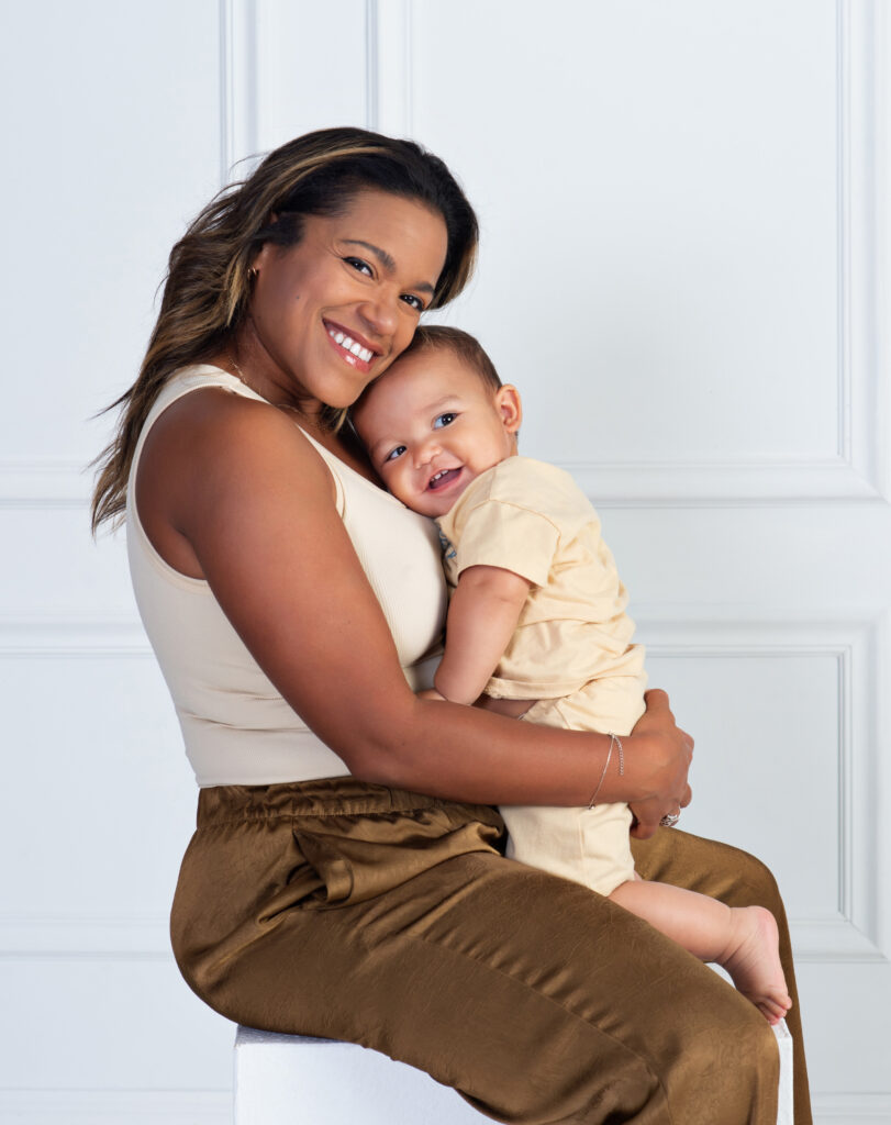 Baby boy snuggling with his mom during his first birthday portrait session