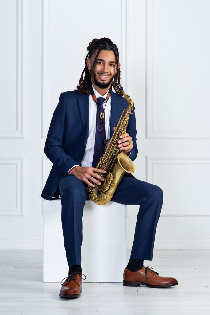 JB with his saxophone for his senior portraits smiling!