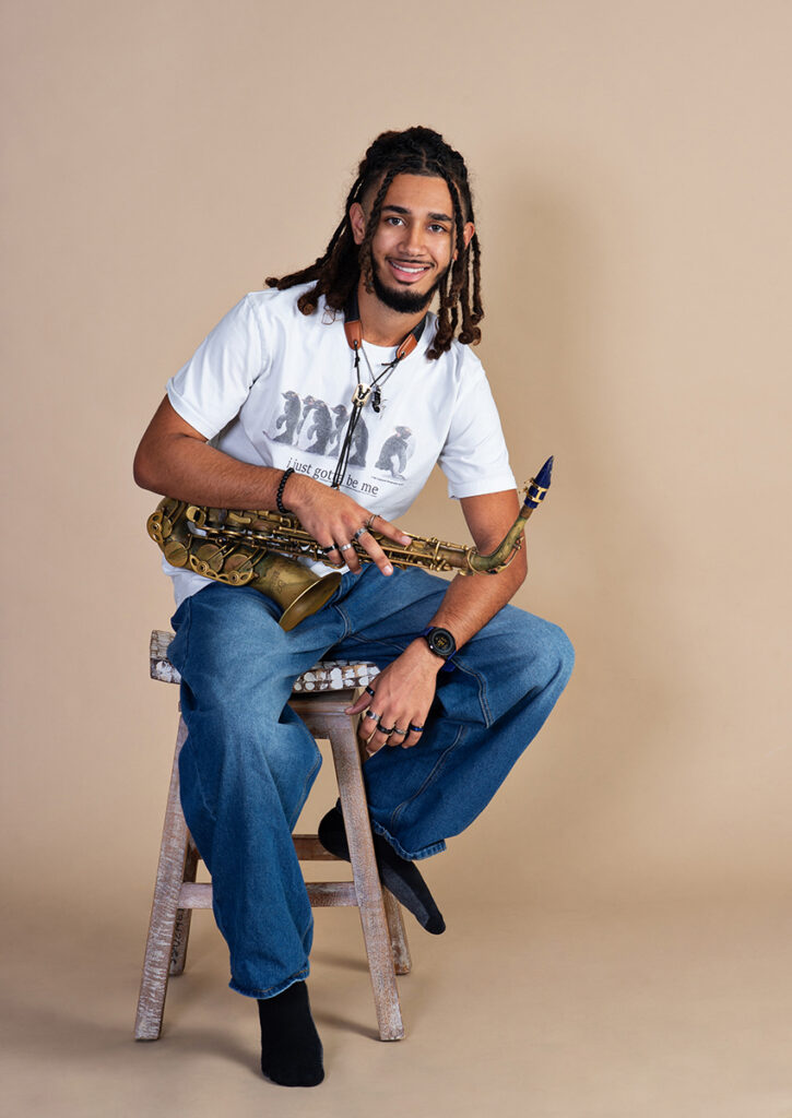 JB holding his saxophone during his senior portrait session at Cloud 9 Studios