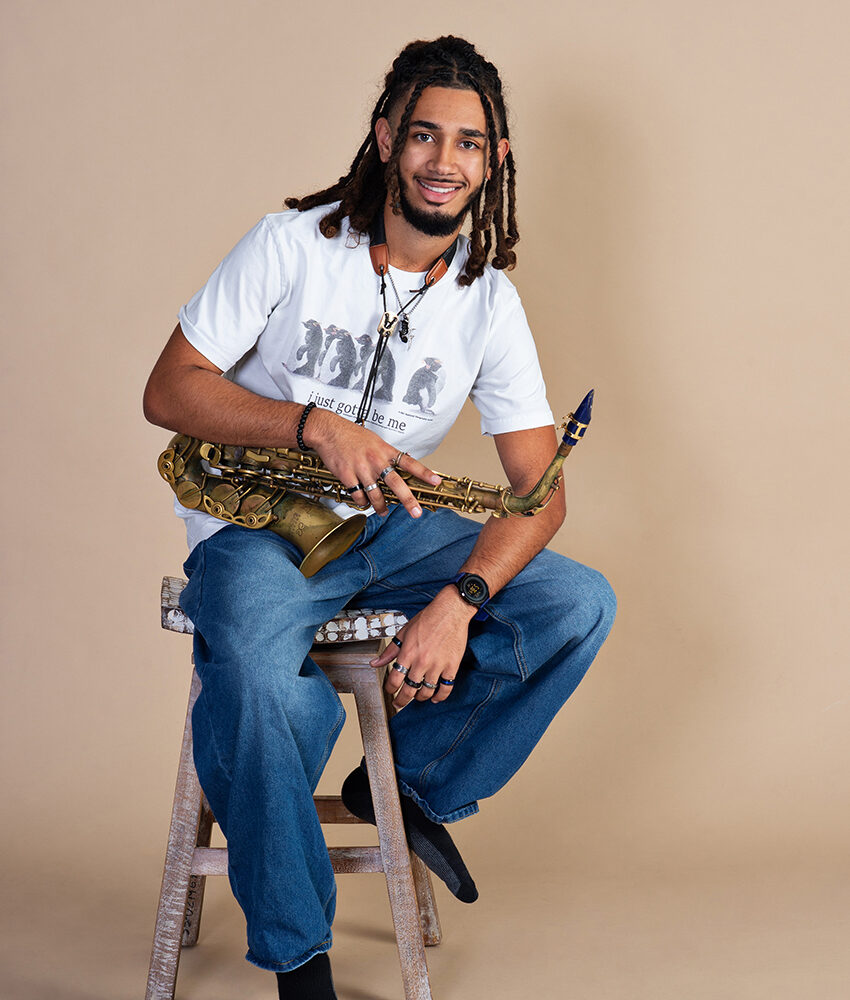 JB holding his saxophone during his senior portrait session at Cloud 9 Studios