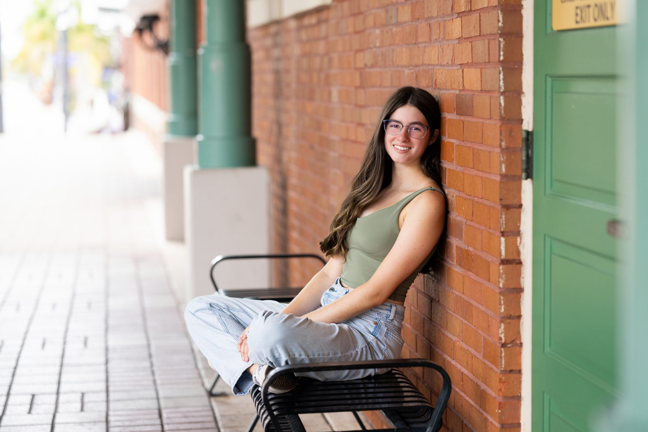 High school senior girl photographed outdoors during her senior portrait experience with Cloud 9 Studios