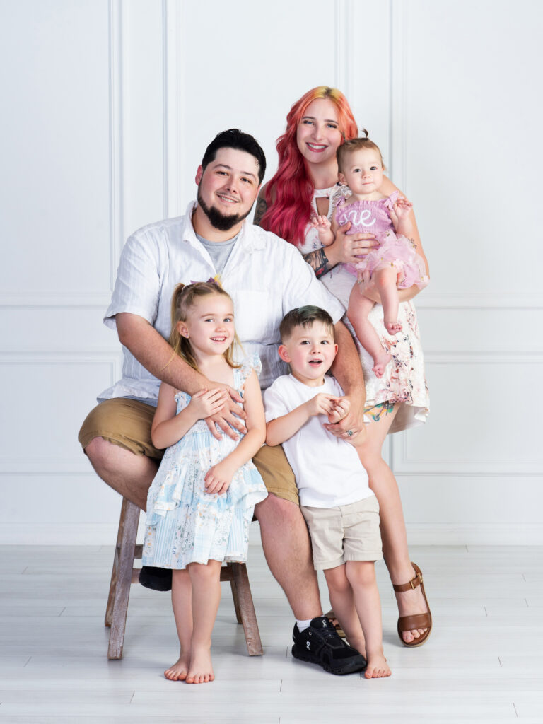 Family portrait of parents with their three young children at Cloud 9 Studios in Wesley Chapel, Florida