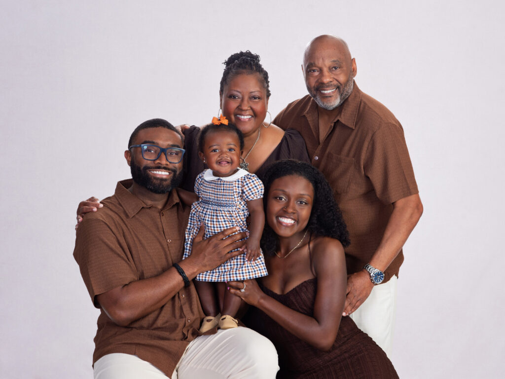 Grandparents, parents and young granddaughter together for a multigenerational family portrait in Wesley Chapel, Florida