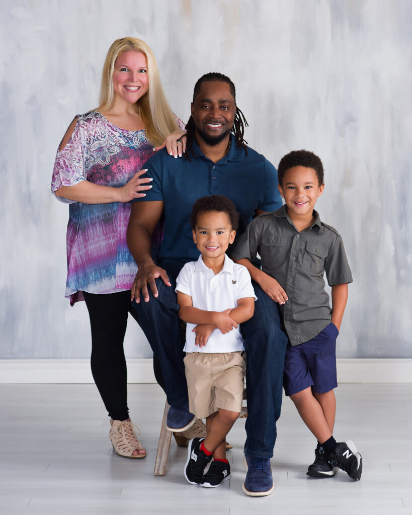 Relaxed family portrait with parents and two young boys at Cloud 9 Studios in Wesley Chapel, Florida