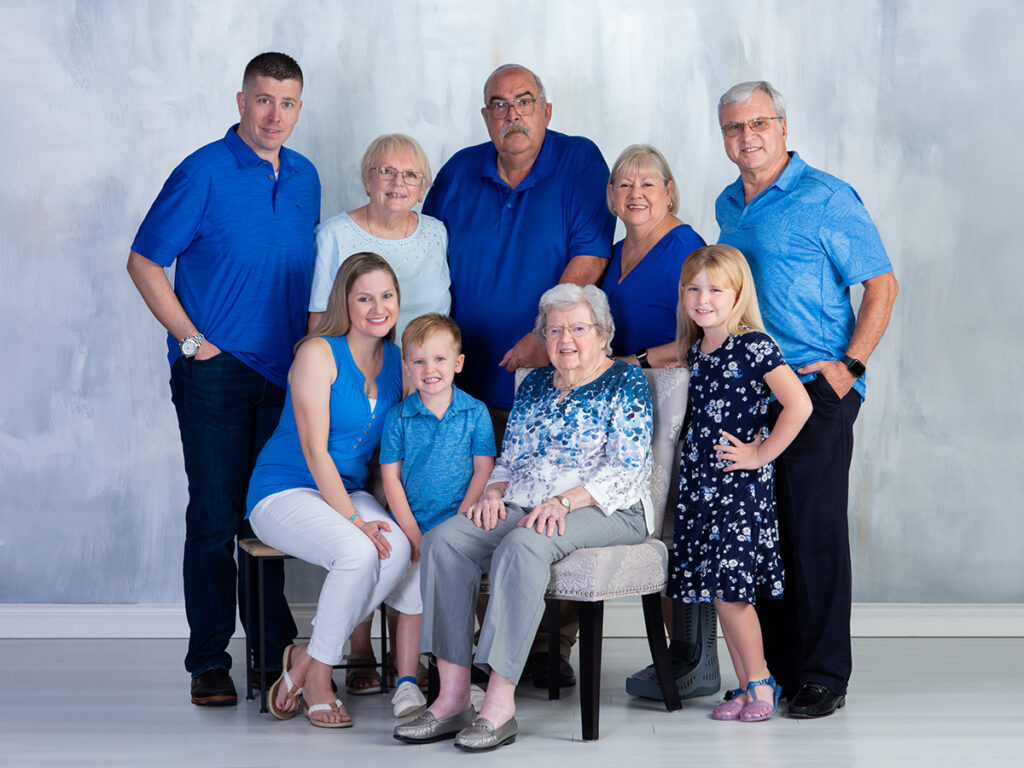Four generations of a family celebrating their great-grandmother's 100th birthday with a portrait at Cloud 9 Studios.